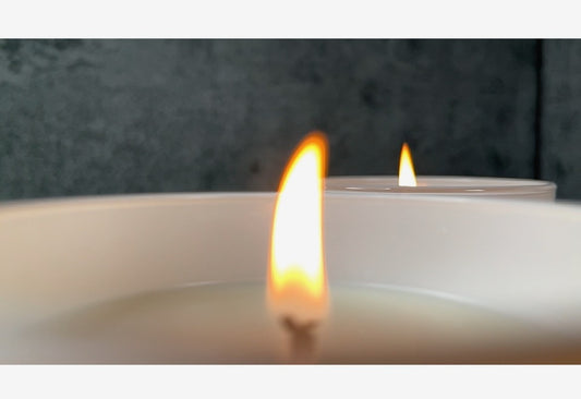 Lit candle with stones surrounding; White Background